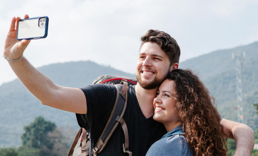 Couple taking a selfie outside