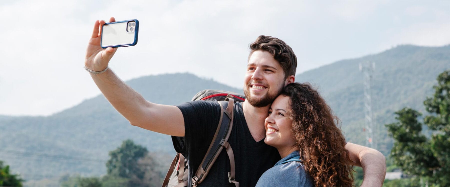 Couple taking a selfie outside