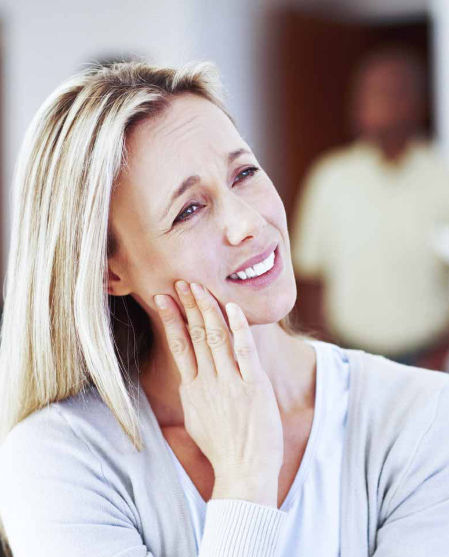 Woman holding face in pain